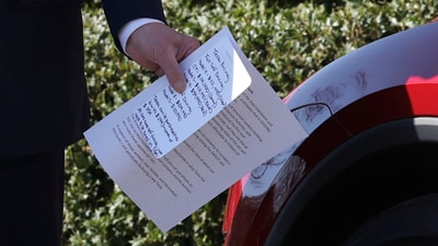 Donald Trump holds notes about Tesla cars while being shown various models parked in front of the White House in Washington, DC, US, on &nbsp;March 11, 2025.&nbsp; (Kevin Lamarque/REUTERS)