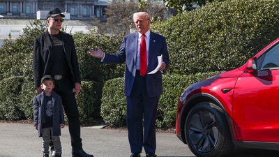 Donald Trump and Elon Musk, along with his son X Æ A-Xii, speak to reporters near Tesla vehicles on South Lawn of the White House. (AP)
