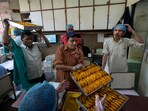 Workers carry Gujiyas, a sweet dish, specially made for the Holi festival, before packing for customers at a sweet shop in New Delhi. Workers carry Gujiyas, a sweet dish, specially made for the Holi festival, before packing for customers at a sweet shop in New Delhi.