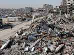 A Palestinian walks past a rubble of houses destroyed during the Israeli offensive, in Rafah, in the southern Gaza Strip, March 13, 2025.