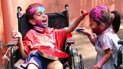 Two disabled children in Agripada Mumbai were captured engaging in the playful tradition of applying colours to each other on the occasion of Holi (Jitendra Takale/ANI) Two disabled children in Agripada Mumbai were captured engaging in the playful tradition of applying colours to each other on the occasion of Holi (Jitendra Takale/ANI)