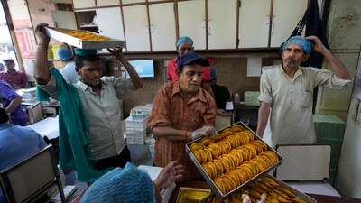 Workers carry Gujiyas, a sweet dish, specially made for the Holi festival, before packing for customers at a sweet shop in New Delhi. (Representational image) Workers carry Gujiyas, a sweet dish, specially made for the Holi festival, before packing for customers at a sweet shop in New Delhi. (Representational image)