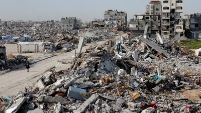 A Palestinian walks past a rubble of houses destroyed during the Israeli offensive, in Rafah, in the southern Gaza Strip, March 13, 2025. (Reuters)