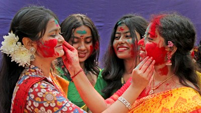 Youth at Santiniketan apply colours to each other, amid reports of a ban on the festivities in the region (PTI) Youth at Santiniketan apply colours to each other, amid reports of a ban on the festivities in the region (PTI)