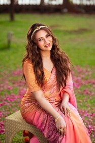 Divyanka glows in a peach-pink saree with delicate sequins and floral motifs from Asha Gautam. A shimmer blouse and elegant pieces from Rubans and Vasundhara Jewelry tie the look together Divyanka glows in a peach-pink saree with delicate sequins and floral motifs from Asha Gautam. A shimmer blouse and elegant pieces from Rubans and Vasundhara Jewelry tie the look together