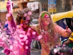 Foreign tourists participate in Holi celebrations along with locals in Paharganj, in New Delhi.