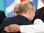 Russia's President Vladimir Putin and Prime Minister Narendra Modi embrace at the end of the extended format meeting of the BRICS summit.