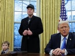 US President Donald Trump speaks next to Elon Musk and X Æ A-12, Musk's son, in the Oval Office of the White House in Washington.