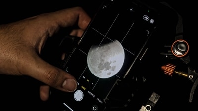 The full moon eclipse is seen through a mobile phone at the Foster Observatory telescope in Santiago, Chile, on March 14, 2025. (AFP) The full moon eclipse is seen through a mobile phone at the Foster Observatory telescope in Santiago, Chile, on March 14, 2025. (AFP)