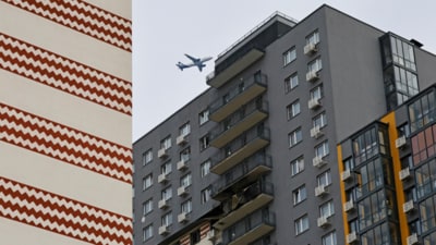 A plane flies over a multi-storey residential building damaged in a recent Ukrainian drone attack, according to local authorities, in the course of Russia-Ukraine conflict, in Vidnoye, Moscow Region, Russia March 11, 2025 (Reuters)