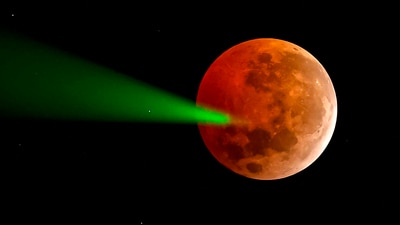 The full moon eclipse is targeted with a laser from the Foster Observatory telescope in Santiago, Chile, on March 14, 2025. (AFP) The full moon eclipse is targeted with a laser from the Foster Observatory telescope in Santiago, Chile, on March 14, 2025. (AFP)
