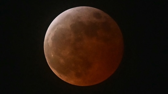 A lunar eclipse is seen during the Blood Moon Lunar Eclipse above Los Angeles, California, on March 13, 2025. (Photo by Frederic J. Brown / AFP) (AFP)