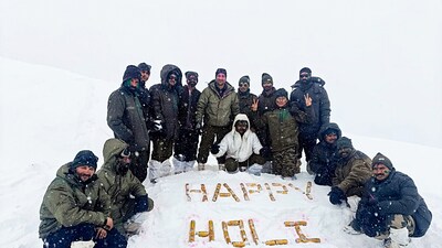 Border Security Force (BSF) personnel pose for a picture amid heavy snowfall atop a mountain as they celebrate the Holi festival, on Friday. (Gourav) Border Security Force (BSF) personnel pose for a picture amid heavy snowfall atop a mountain as they celebrate the Holi festival, on Friday. (Gourav)