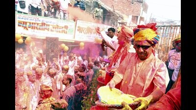 Chief minister Yogi Adityanath hurls coloured powder on people during a procession on the occasion of Holi, in Gorakhpur. (SOURCED) Chief minister Yogi Adityanath hurls coloured powder on people during a procession on the occasion of Holi, in Gorakhpur. (SOURCED)