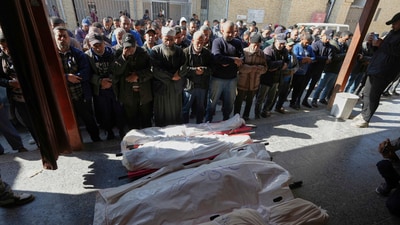 Mourners pray over the bodies of four Palestinians killed by an Israeli airstrike in the Netzarim corridor, at the Al-Ahli Hospital in Gaza City on Tuesday, March 11, 2025. (AP) Mourners pray over the bodies of four Palestinians killed by an Israeli airstrike in the Netzarim corridor, at the Al-Ahli Hospital in Gaza City on Tuesday, March 11, 2025. (AP)