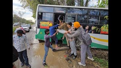 Locals helping passengers exit the bus which collided with a combine near Karnal on Saturday. (HT Photo)