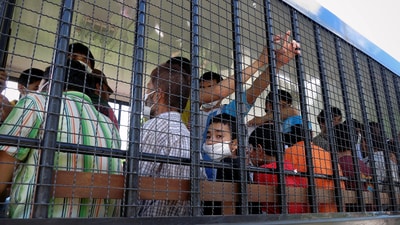 Suspected Uyghurs are transported back to a detention facility in the town of Songkhla in southern Thailand after visiting women and children at a separate shelter March 26, 2014. (REUTERS)