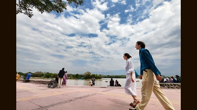 Tourists enjoying a stroll under the cloud cover at Sukhna Lake in Chandigarh on Saturday. (Ravi Kumar/HT)