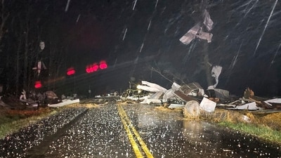 Debris covers the road during a severe storm passed the area north of Seymour, Mo., in Webster County late Friday, (AP) Debris covers the road during a severe storm passed the area north of Seymour, Mo., in Webster County late Friday, (AP)