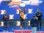 McLaren's Lando Norris celebrates with the trophy on the podium after winning the Australian Grand Prix