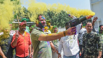 Rashtriya Janata Dal (RJD) MLA Tej Pratap shoots hues in the air while celebrating Holi with party workers at his residence, in Patna on Saturday. (ANI Photo) (Pappi Sharma ) Rashtriya Janata Dal (RJD) MLA Tej Pratap shoots hues in the air while celebrating Holi with party workers at his residence, in Patna on Saturday. (ANI Photo) (Pappi Sharma )