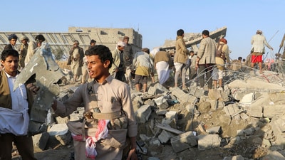 A man holds a fragment of a missile at the site of a US strike in Saada, Yemen, March 16, 2025. (Reuters)