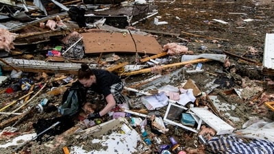On person was seen searching through the wreckage of her home inside of her trailer park, after the devastation caused by the storms. (Getty Images via AFP) On person was seen searching through the wreckage of her home inside of her trailer park, after the devastation caused by the storms. (Getty Images via AFP)