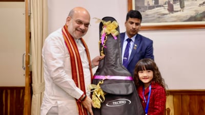 Union Home Minister Amit Shah, during his visit to the Northeast on Saturday, gifted a guitar to 7-year-old Mizoram prodigy Esther Lalduhawmi Hnamte. (X/Amit Shah) Union Home Minister Amit Shah, during his visit to the Northeast on Saturday, gifted a guitar to 7-year-old Mizoram prodigy Esther Lalduhawmi Hnamte. (X/Amit Shah)