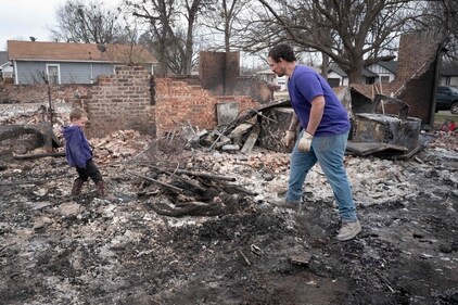 Zach Johnson and his son Owen salvage items from their home after it was destroyed by yesterday's wildfire on March 15, 2025 in Mannford, Oklahoma. Governor. Kevin Stitt said that the wildfires fueled by high winds burned around 170,000 acres and damaged 293 homes and structures in the state. (Getty Images via AFP) Zach Johnson and his son Owen salvage items from their home after it was destroyed by yesterday's wildfire on March 15, 2025 in Mannford, Oklahoma. Governor. Kevin Stitt said that the wildfires fueled by high winds burned around 170,000 acres and damaged 293 homes and structures in the state. (Getty Images via AFP)