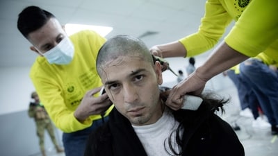 An alleged member of the Venezuelan criminal organization Tren de Aragua being shaved upon his arrival at the Terrorism Confinement Center (CECOT) in the city of Tecoluca, El Salvador. (AFP)