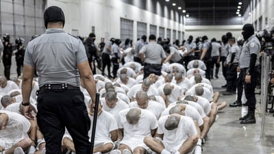 A prison guard transfers deportees from the U.S., alleged to be Venezuelan gang members, to the Terrorism Confinement Center in Tecoluca, El Salvador, Sunday, March 16, 2025. (AP)
