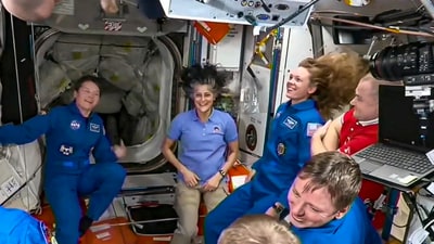In this screenshot from a NASA video shows Suni Williams and other astronauts greeting each other after the SpaceX capsule docked with the International Space Station, Sunday, March 16 (NASA) In this screenshot from a NASA video shows Suni Williams and other astronauts greeting each other after the SpaceX capsule docked with the International Space Station, Sunday, March 16 (NASA)