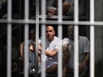 Inmates look on as they remain in a cell at the Counter-Terrorism Confinement Centre (CECOT) mega-prison. Inmates look on as they remain in a cell at the Counter-Terrorism Confinement Centre (CECOT) mega-prison.