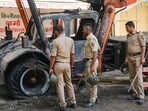 Nagpur: Police personnel near charred remains of a vehicle, a day after violence broke out following an agitation by a right-wing group demanding removal of Aurangzeb's tomb, in Nagpur. Nagpur: Police personnel near charred remains of a vehicle, a day after violence broke out following an agitation by a right-wing group demanding removal of Aurangzeb's tomb, in Nagpur.