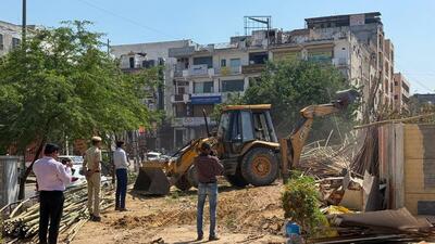 An enforcement team of GMDA carried out demolition against the illegal encroachment on MG road near Sikanderpur metro station on Tuesday. (Parveen Kumar/HT Photo)