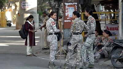 Nagpur violence: Women security personnel keep a vigil in the aftermath of violence that erupted on Monday. Several houses, vehicles and a clinic have been vandalised in violence in Nagpur following rumours that the holy book of a community was burnt during an agitation by a right-wing body for the removal of Mughal emperor Aurangzeb's tomb. (PTI) Nagpur violence: Women security personnel keep a vigil in the aftermath of violence that erupted on Monday. Several houses, vehicles and a clinic have been vandalised in violence in Nagpur following rumours that the holy book of a community was burnt during an agitation by a right-wing body for the removal of Mughal emperor Aurangzeb's tomb. (PTI)