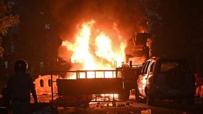 TOPSHOT - A firefighter stands near the burning vehicles set on fire following clashes at the Chitnavis Park Square area, in Nagpur on March 17. (AFP) TOPSHOT - A firefighter stands near the burning vehicles set on fire following clashes at the Chitnavis Park Square area, in Nagpur on March 17. (AFP)
