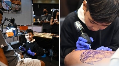 Nine-year-old Napat Mitmakorn, a Thai child tattoo artist, works on his uncle’s tattoo. (AFP) Nine-year-old Napat Mitmakorn, a Thai child tattoo artist, works on his uncle’s tattoo. (AFP)