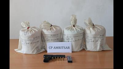 The commissionerate police, Amritsar, on Tuesday busted a cross-border drug cartel with the arrest of a person and recovery of 8.08 kg of heroin, a .30-bore pistol and five cartridges from his possession. The commissionerate police, Amritsar, on Tuesday busted a cross-border drug cartel with the arrest of a person and recovery of 8.08 kg of heroin, a .30-bore pistol and five cartridges from his possession.