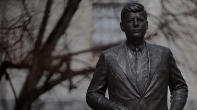 A statue of President John F. Kennedy stands outside the State House, (REUTERS)