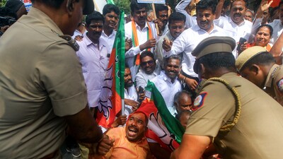 Police personnel detained BJP supporters during their protest over an alleged TASMAC liquor scam Police personnel detained BJP supporters during their protest over an alleged TASMAC liquor scam