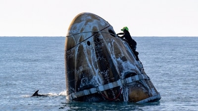 Support crew members also worked on cleaning up after the SpaceX capsule landed in the water and the astronauts had been rescued (AP)