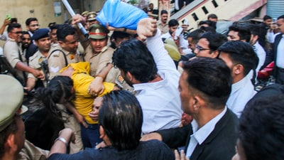 Police intervene as lawyers trash accused Sahil Shukla while he was being produced in a court in connection with Merchant Navy officer Saurabh Rajput's killing, in Meerut, Wednesday, March 19, 2025. (PTI) Police intervene as lawyers trash accused Sahil Shukla while he was being produced in a court in connection with Merchant Navy officer Saurabh Rajput's killing, in Meerut, Wednesday, March 19, 2025. (PTI)