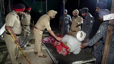 Policemen removing farmers at the Punjab-Haryana border in Shambhu village of Patiala district on Wednesday. ( (ANI) Policemen removing farmers at the Punjab-Haryana border in Shambhu village of Patiala district on Wednesday. ( (ANI)
