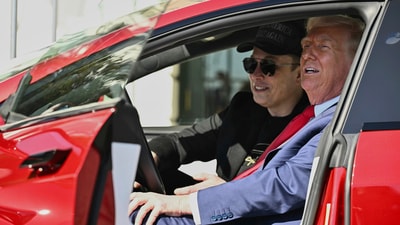 Donald Trump and Elon Musk speak to reporters as they sit in the red Model S Tesla vehicle on the South Lawn of the White House. (AP) Donald Trump and Elon Musk speak to reporters as they sit in the red Model S Tesla vehicle on the South Lawn of the White House. (AP)