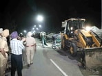 A backhoe loader being used to dismantle temporary structures set up by agitating farmers during an eviction drive by the Punjab Police to remove them from the Shambhu border, in Patiala district, Wednesday night, March 19, 2025. A backhoe loader being used to dismantle temporary structures set up by agitating farmers during an eviction drive by the Punjab Police to remove them from the Shambhu border, in Patiala district, Wednesday night, March 19, 2025.