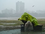Tea sellers covered themselves with plastic sheets to protect from sudden rainfall at Maidan area in Kolkata, India. (File)