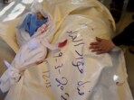 In this image made from an Associated Press video, the bodies of Afnan al-Ghanam, who was 7 months pregnant, and her young son, Mohammed, are prepared for burial in Khan Younis, Gaza Strip, Wednesday, March 19, 2025. They were killed before dawn on Tuesday by an Israeli airstrike. In this image made from an Associated Press video, the bodies of Afnan al-Ghanam, who was 7 months pregnant, and her young son, Mohammed, are prepared for burial in Khan Younis, Gaza Strip, Wednesday, March 19, 2025. They were killed before dawn on Tuesday by an Israeli airstrike.