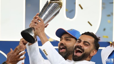India's Virat Kohli, right, and captain Rohit Sharma celebrate with the winners trophy on the podium. (AP)