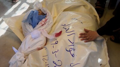 In this image made from an Associated Press video, the bodies of Afnan al-Ghanam, who was 7 months pregnant, and her young son, Mohammed, are prepared for burial in Khan Younis, Gaza Strip, Wednesday, March 19, 2025. They were killed before dawn on Tuesday by an Israeli airstrike. (AP)